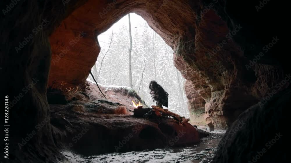 Prehistoric caveman touches snow in times of stone age on ...
