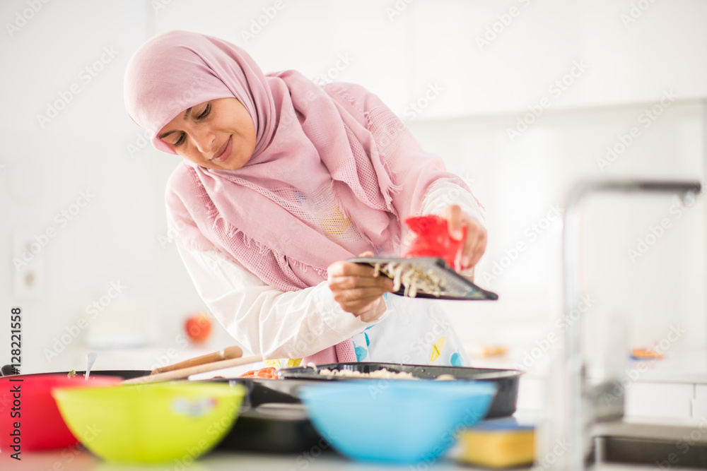 Muslim Arabic traditional woman in kitchen preparing food for lu Muslim Arabic traditional woman in kitchen preparing food for lu