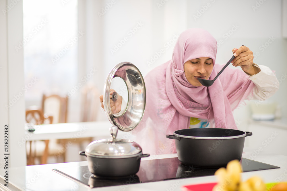 Arabic beautiful housewife making a lunch in kitchen Arabic beautiful housewife making a lunch in kitchen