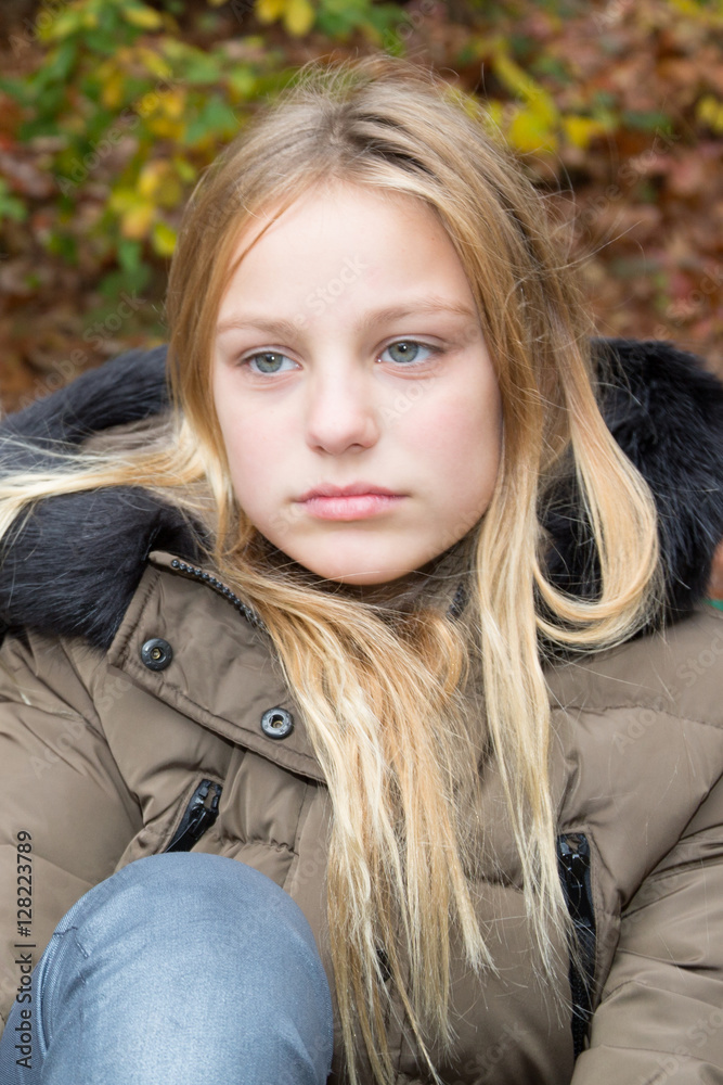 sad teenager girl with long blonde hair and green eyes Stock Photo | Adobe  Stock