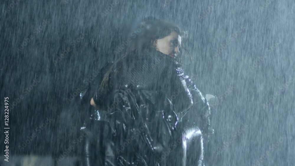 Couple runs on motorcycle in the heavy rain. Shot on RED EPIC Cinema Camera in slow motion.