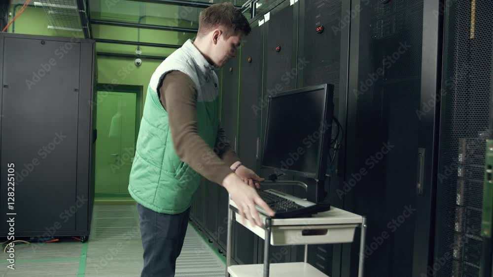 an Employee of the Data Center Working in the Server Room an Employee of the Data Center Working in the Server Room