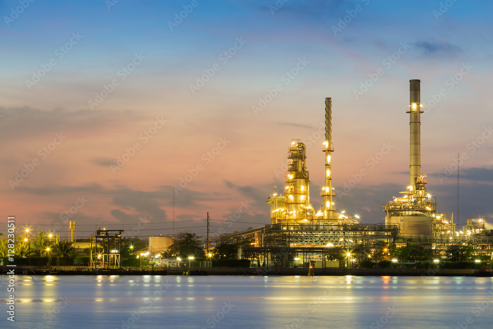 Oil refinery light river front with twilight sky background