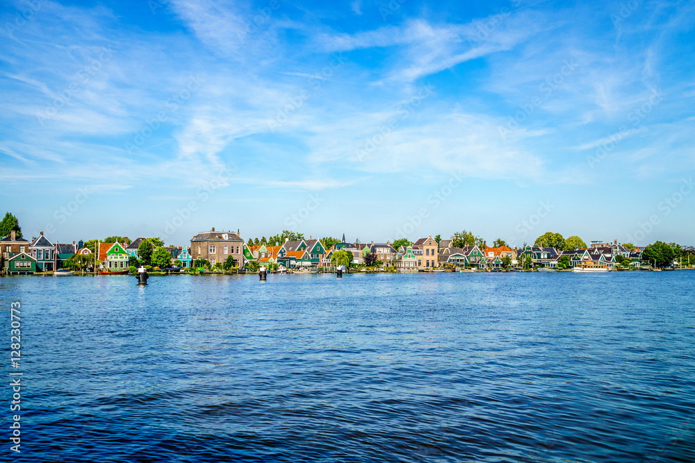 Obraz premium The Village of Zaandijk with its Traditional Dutch Houses on the Zaan River in the Netherlands