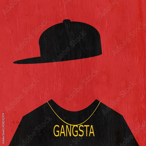 man wearing hip hop fashion and gangsta necklace on wood grain texture