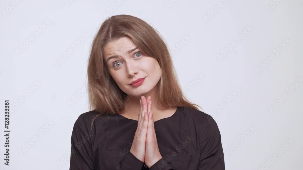 Young beautiful fair-haired girl begging over white background Young beautiful fair-haired girl begging over white background