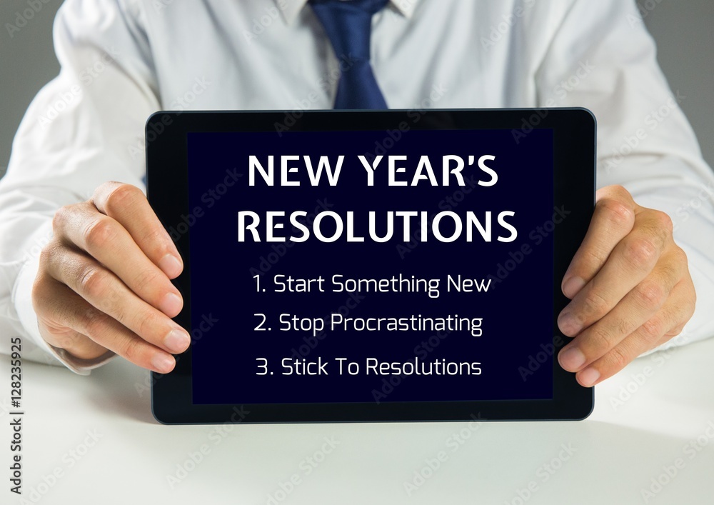 Man holding a digital tablet showing new year resolution goals Man holding a digital tablet showing new year resolution goals
