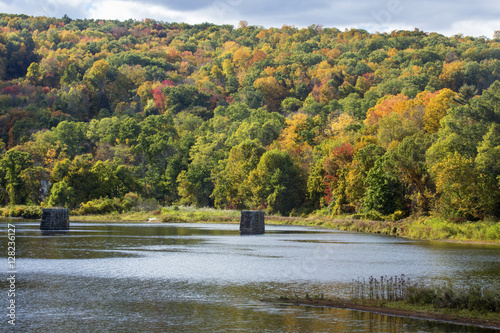 Old bridge pillars stand in the Farmington River, Collinsville, Connecticut. photo