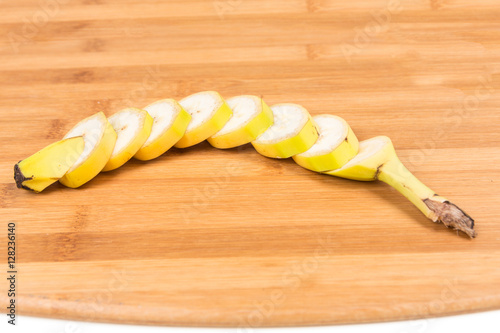 Banana cut up shallow depth of field isolated on wood background