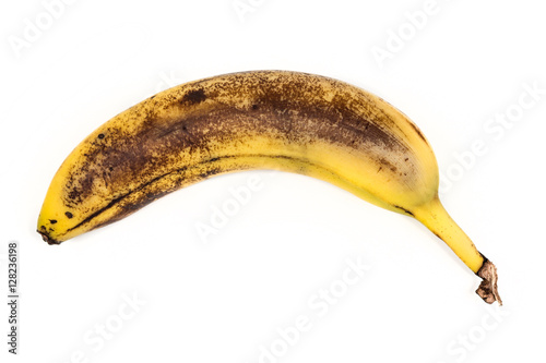 Fényképezés Old beaten banana isolated on white background