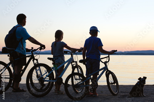 Biker family silhouette. Happy family - father with two kids on