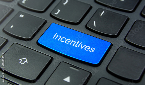 Business Concept: Close-up the Incentives button on the keyboard and have Azure, Cyan, Blue, Sky color button isolate black keyboard