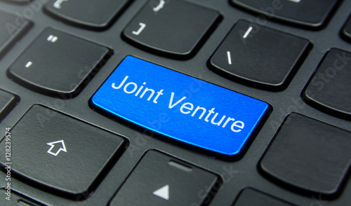 Business Concept: Close-up the Joint Venture button on the keyboard and have Azure, Cyan, Blue, Sky color button isolate black keyboard