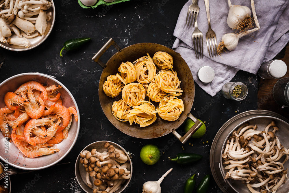 Cooking ingredients with seafood, pasta and mix chinese mushrooms. Tagliatelle pasta with