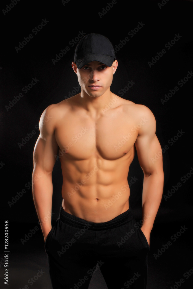 handsome bodybuilder man with a naked torso showing muscles in the cap handsome bodybuilder man with a naked torso showing muscles in the cap
