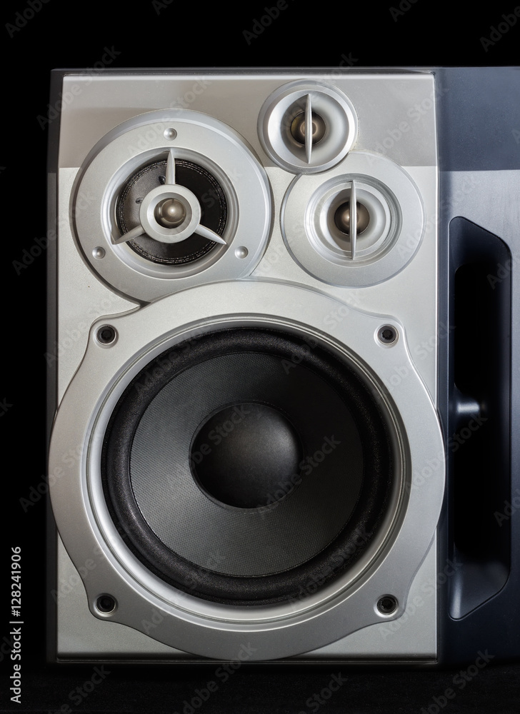 Home three-way loudspeaker system on a dark background Home three-way loudspeaker system on a dark background