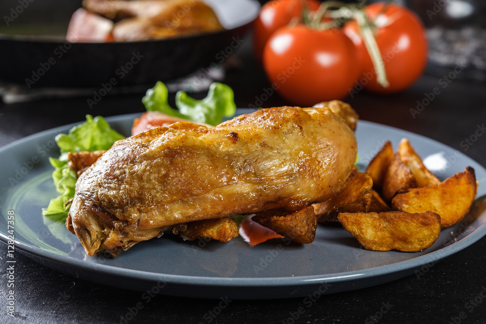 Roasted chicken legs with potato wedges and tomatoes Roasted chicken legs with potato wedges and tomatoes