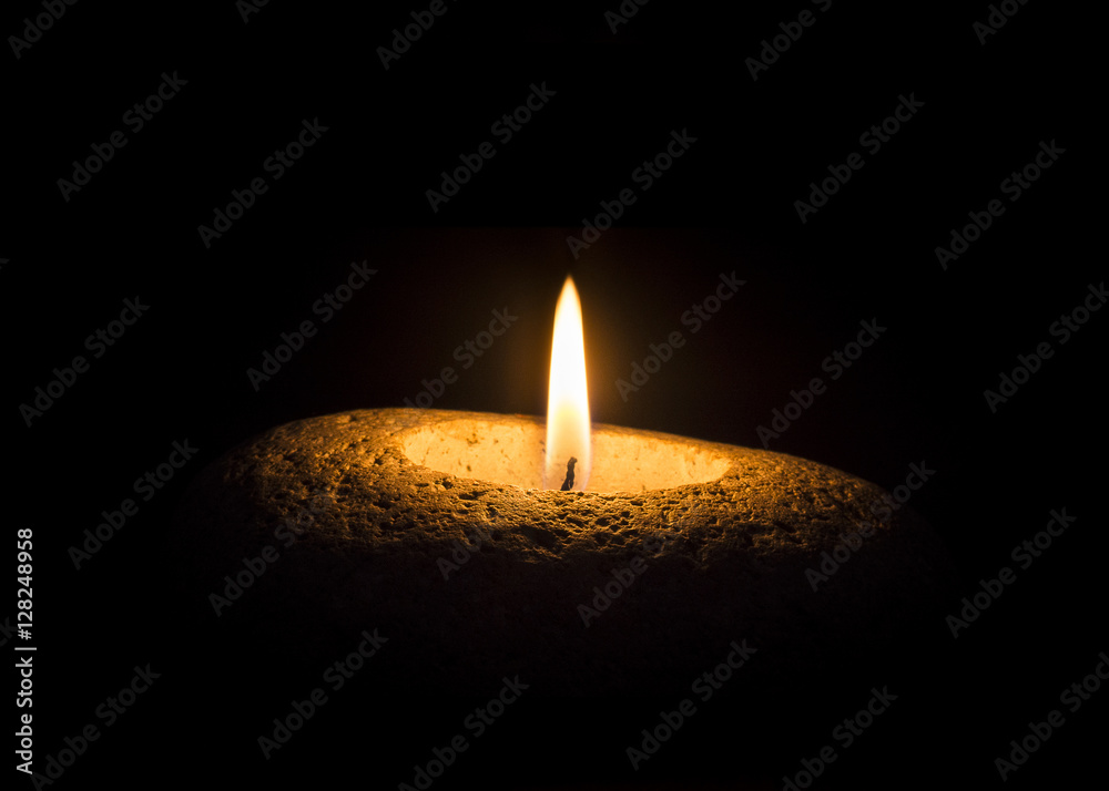 Flame on stone on black background Flame on stone on black background