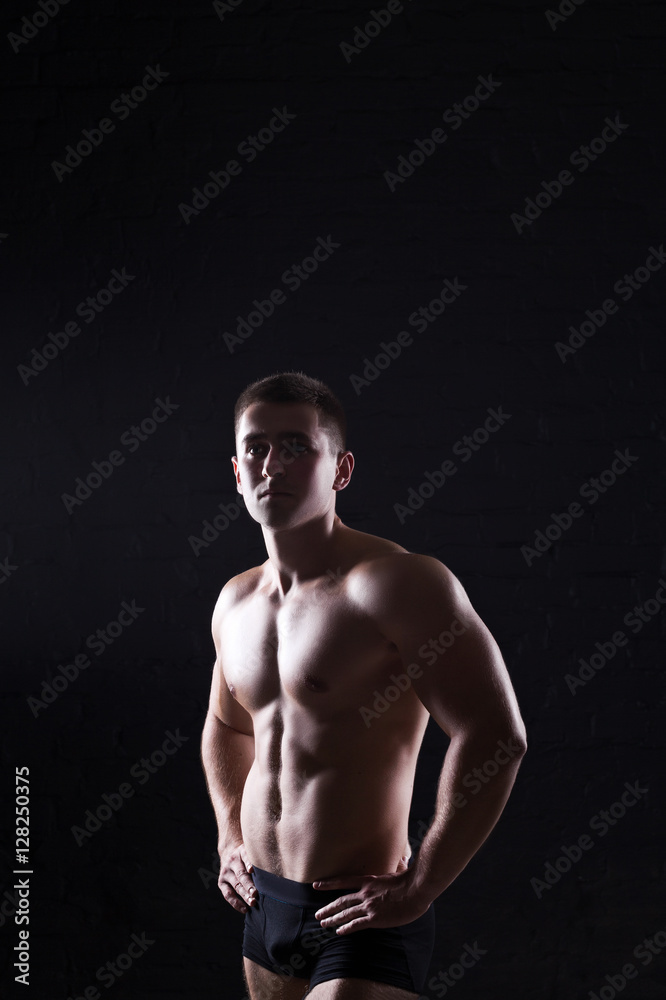 Beautiful and muscular black man's back in dark background Beautiful and muscular black man's back in dark background