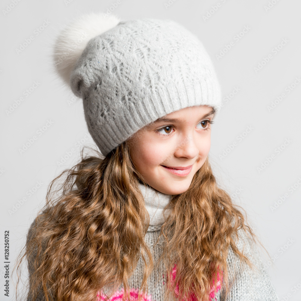 Portrait of a beautiful little girl with magnificent long hair on a gray background Portrait of a beautiful little girl with magnificent long hair on a gray background