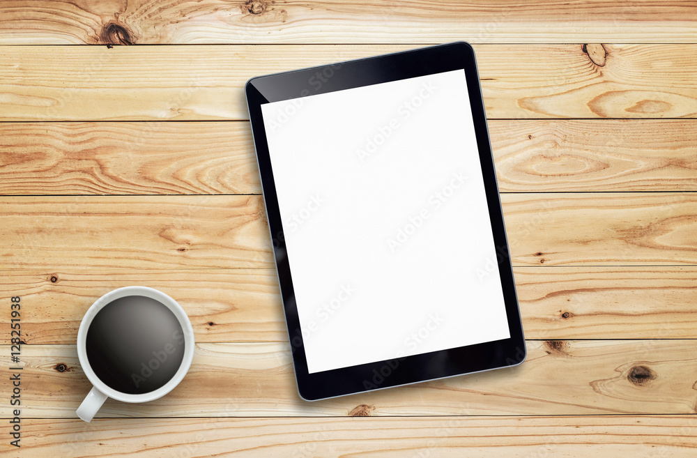 Tablet and coffee of cup on wood table. Tablet and coffee of cup on wood table.