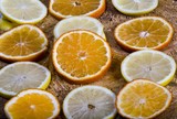Vintage photo, Slices of  lemon and orange lying on old rustic wooden background