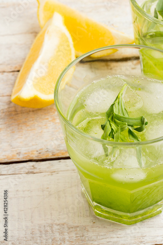 Green lemonade with tarragon and ice closeup