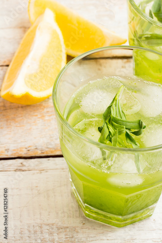 Green lemonade with tarragon and lemon in a glass