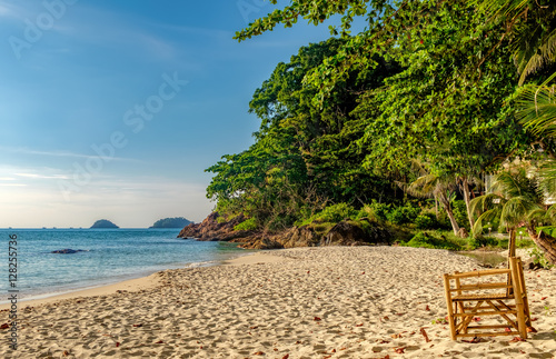Empty bamboo chair on the sand of White Sand Beach  Koh Chang  Thailand. Nature vacation background. Beautiful tropical ocean or sea on sunny day