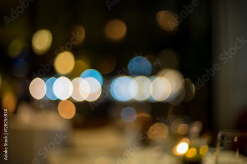 image of blurred bokeh background with colorful lights and Dark background © pasgen