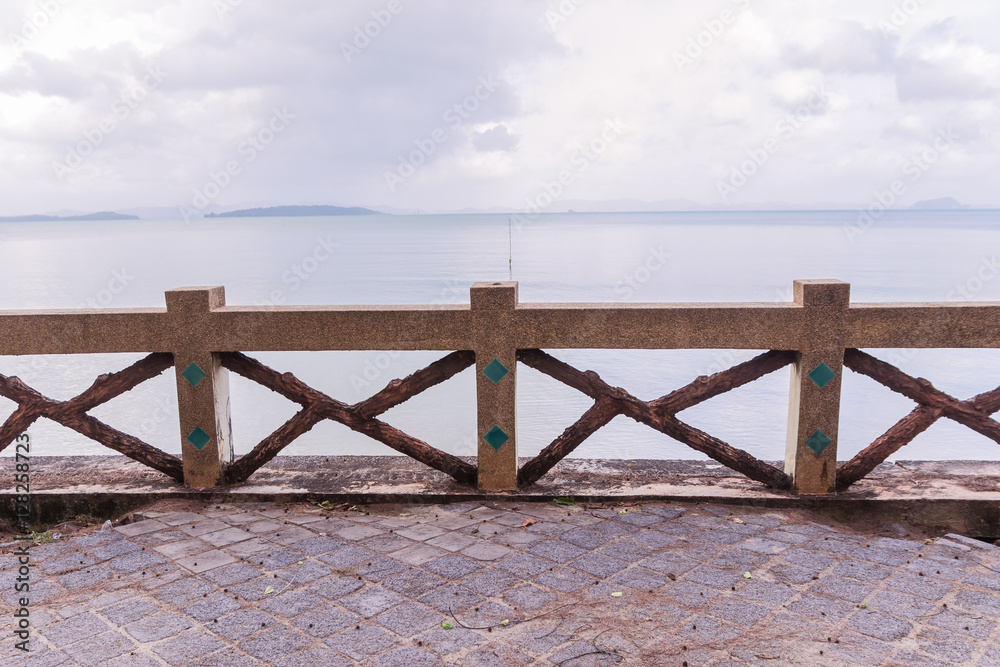 Fototapeta premium Old concrete fence with sand wash finishes at beach
