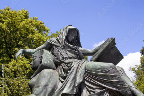 Woman reading book sculpture at "Statue of Otto von Bismarck" in Tiergarten in Berlin. He was a conservative Prussian statesman who dominated German and European affairs from the 1860s until 1890.