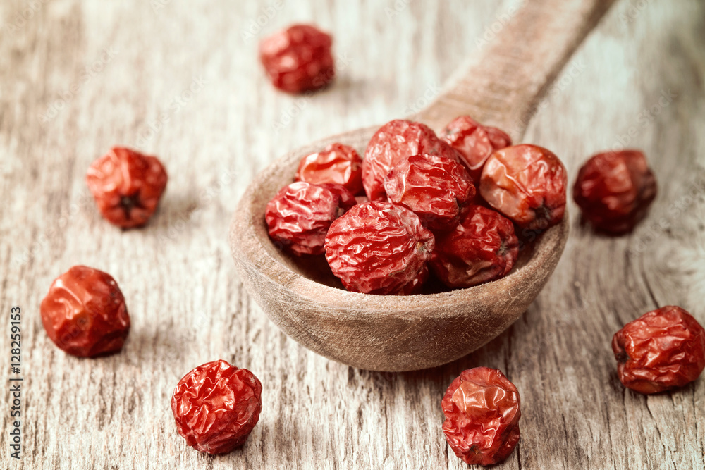Dry ashberries on the wooden spoon Dry ashberries on the wooden spoon