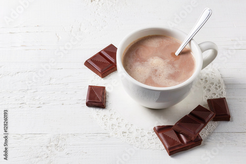 Cup of hot cocoa drink with sweets