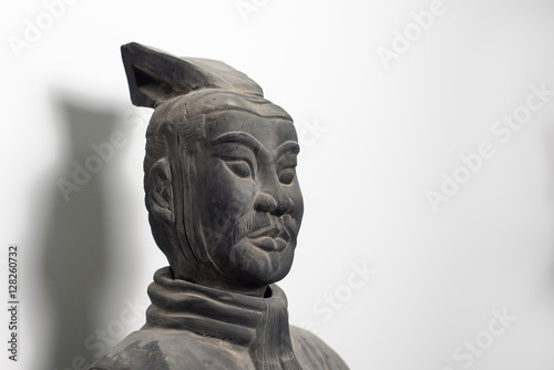 Half profile of Chinese terracotta warrior statue face isolated on white background