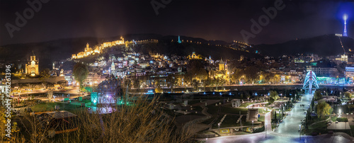 Georgia  Tbilisi. November 23  2016. Panorama of the city at night. Recreation Park Rike  TV tower  Narikala fortress and pedestrian bridge of the world.