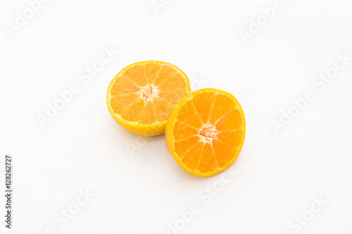 whole and half cut orange on white background