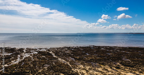 Sea landscape with quiet water and blue sky