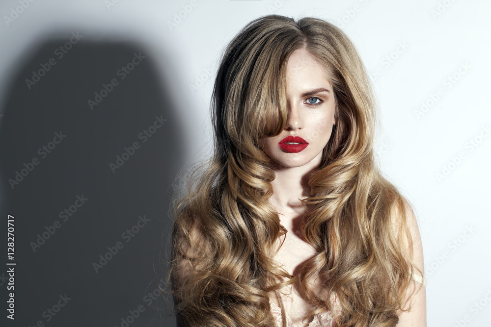 Fototapeta premium blond woman with red lips and long hair with perfect hairstyle on the white background