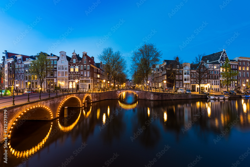 Night city view in Amsterdam, Netherlands. Canal and typical dut