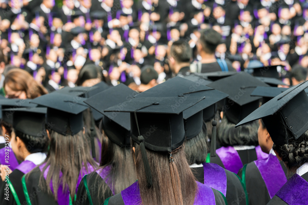 Back of graduates during commencement at university. Back of graduates during commencement at university.