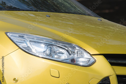 Yellow car headlights. Car exterior details . © littlekai
