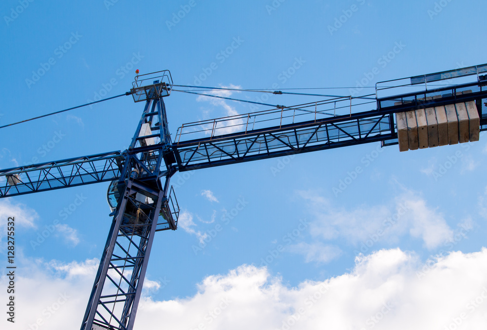 Construction site with cranes on sky background