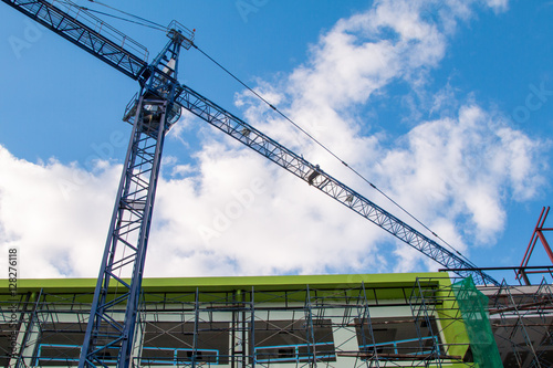 Construction site with cranes on sky background