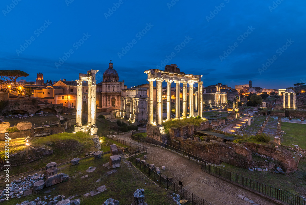 Fototapeta premium Rome (Italy) - The archeological ruins in historic center of Rome, named Imperial Fora. Cityscape from Campidoglio and Via dei Fori Imperiali.