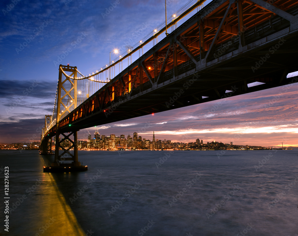 Fototapeta premium San Francisco skyline framed by the Bay Bridge at sunset 