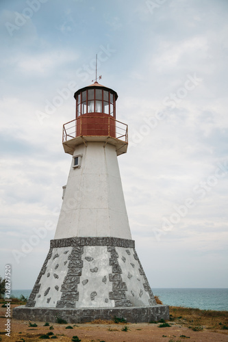 Old white lighthouse on the sea coast