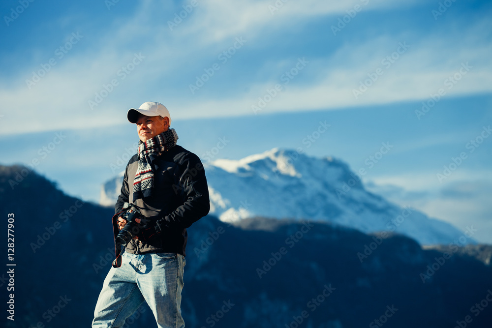 handsome man travel in winter mountains with camera handsome man travel in winter mountains with camera