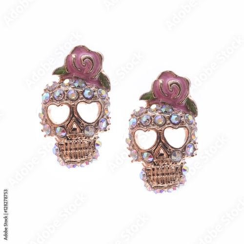 Earrings skull with a rose isolated on white