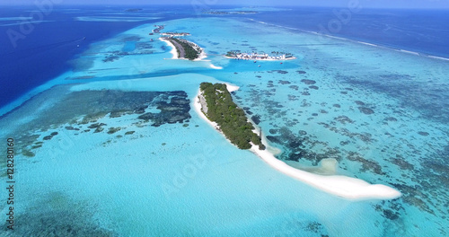 Panoramic landscape seascape aerial view over a Maldives Male Atoll islands. White sandy beach seen from above.